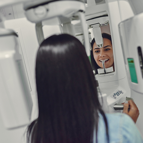 Woman getting a CT cone beam scan of her mouth and jaws